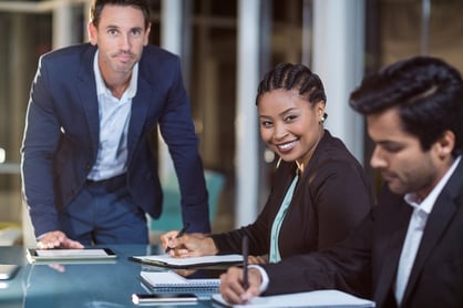 Portrait of businessman and businesswoman sitting in a meeting in the conference room
