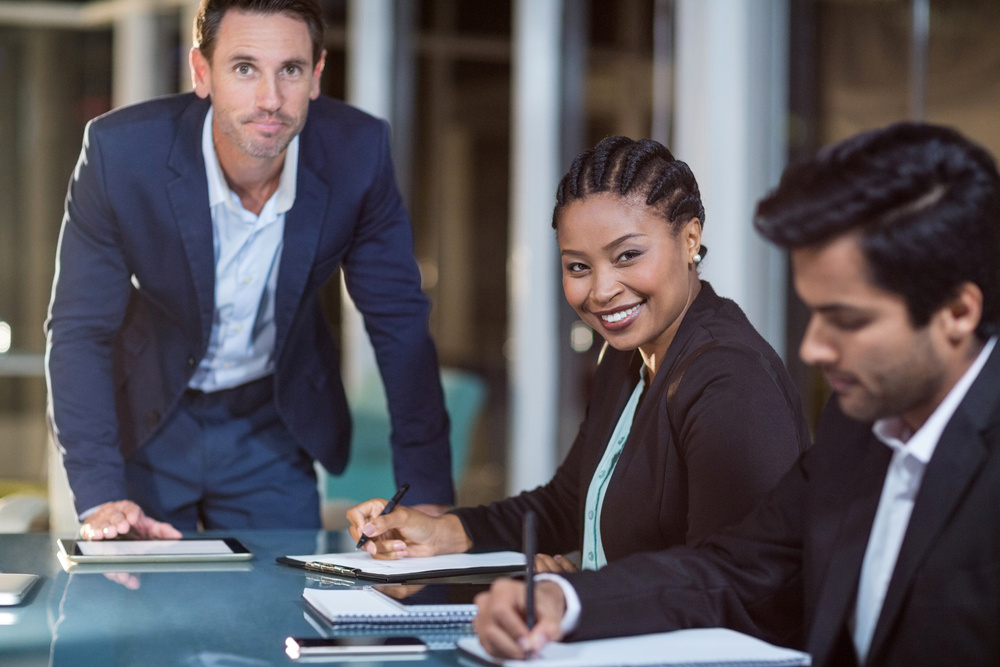 Portrait of businessman and businesswoman sitting in a meeting in the conference room